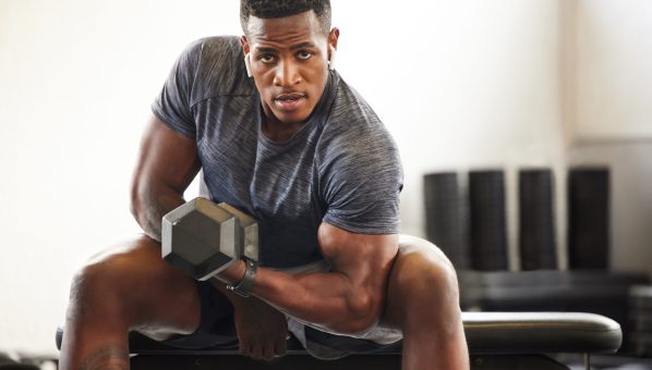 Black man, bodybuilder and dumbbell in gym portrait for fitness, focus or training for growth, goal or competition. African guy, weightlifting and strong arms for training, wellness and muscle health.